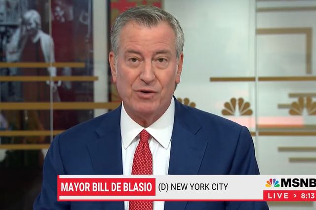Mayor de Blasio on the set of MSNBC, with his name and the MSNBC logo at the bottom